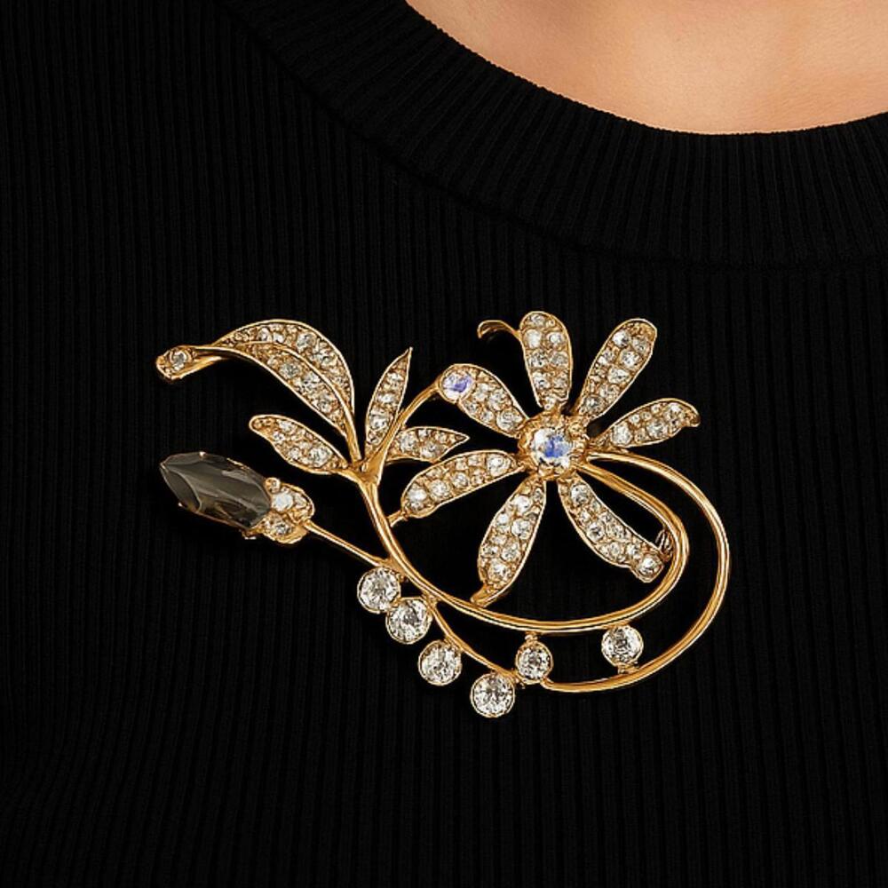 Brand New floral brooch with gold-tone, crystal details, and safety pin closure.